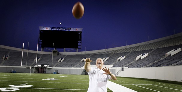 Don Carpenter, a 1977 graduate of the University of Memphis, plays catch during an open house at Liberty Bowl Memorial Stadium on Tuesday evening. Tigers fans in attendance celebrated several upgrades to the stadium including a new high-definition video board in the south end zone.